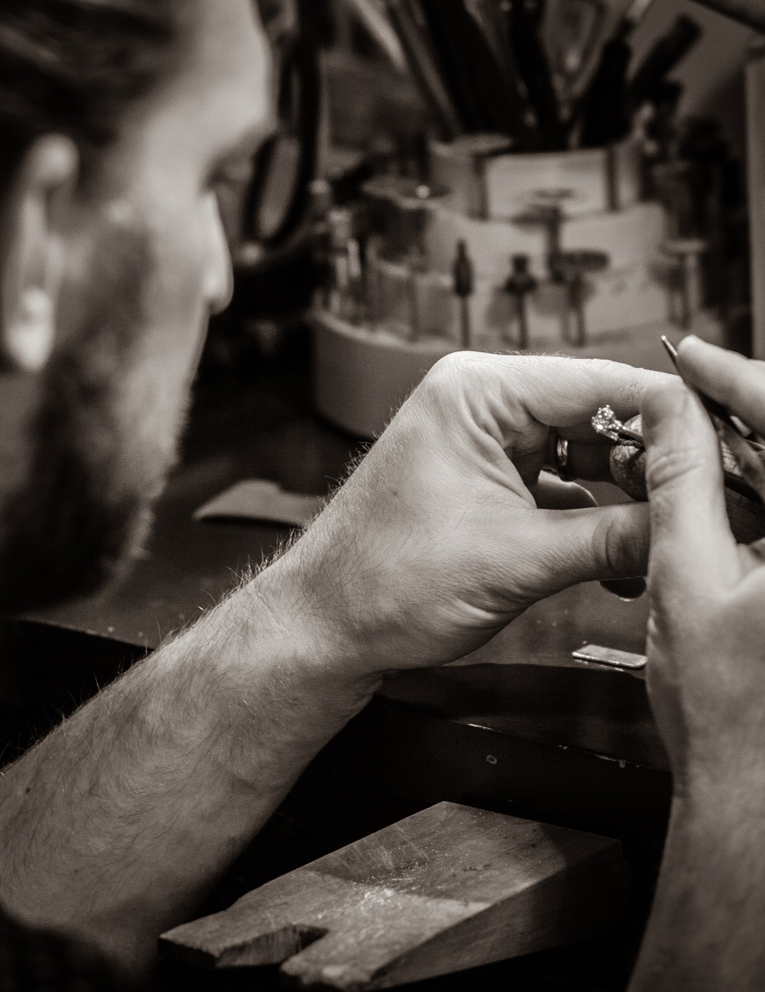Master metalsmith Will from ethical jewelers W.R. Metalarts in his workshop setting a stone in a handcrafted diamond ring.